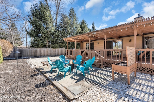 view of patio / terrace with fence, a deck, an outdoor fire pit, and a pergola