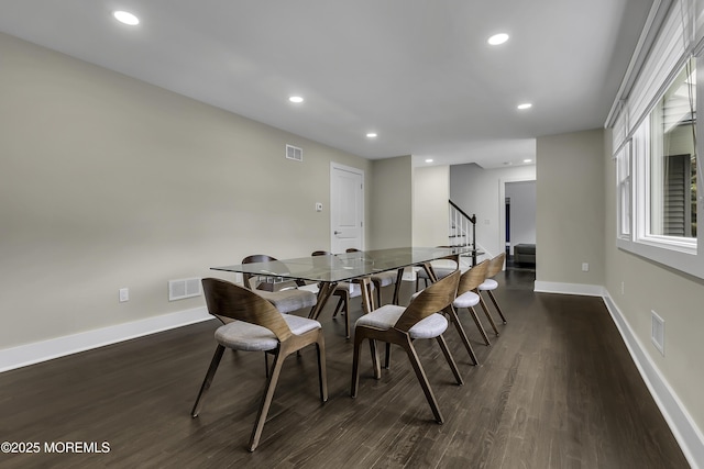 dining space with dark hardwood / wood-style floors