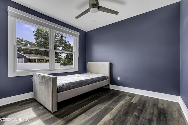 unfurnished bedroom featuring dark wood-type flooring and ceiling fan