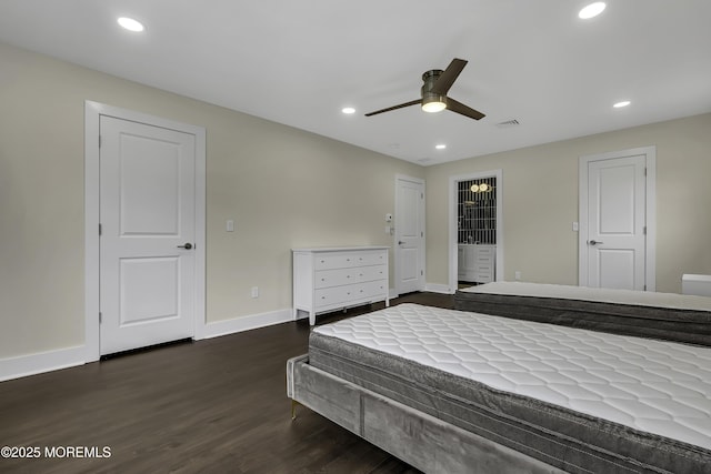 bedroom with dark wood-type flooring, ceiling fan, and ensuite bath