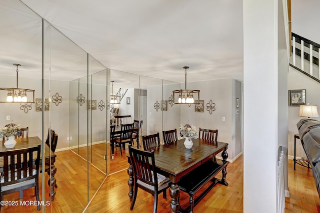 dining space with a chandelier and light hardwood / wood-style floors