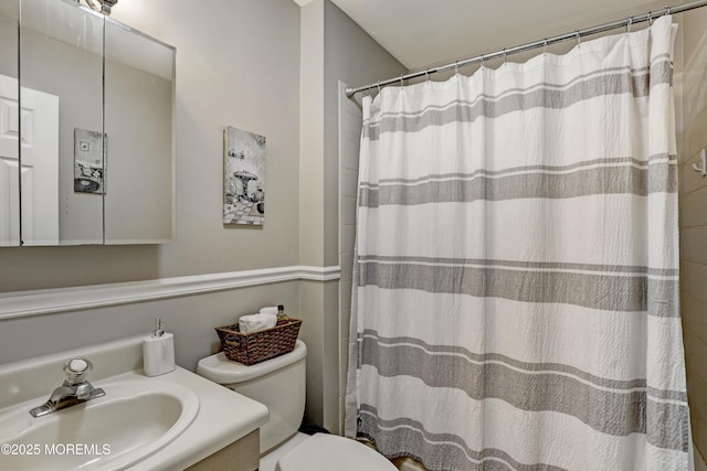 bathroom with vanity, toilet, and a shower with shower curtain