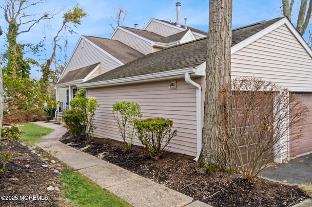 view of side of property with a garage