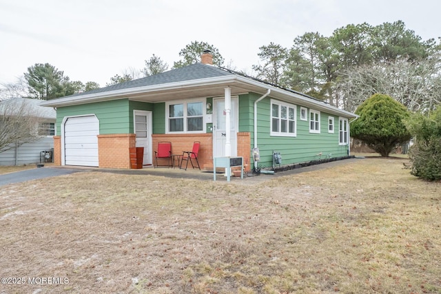 single story home with a garage and a front yard