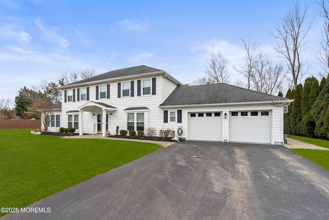 view of front of property featuring aphalt driveway, a garage, a shingled roof, and a front lawn