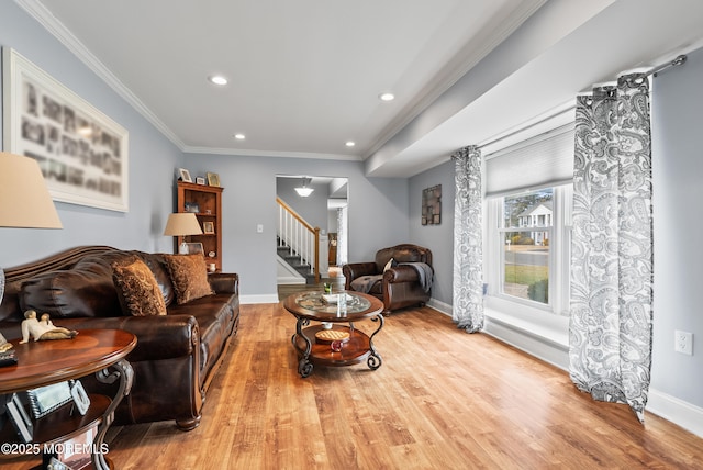 living area with baseboards, stairs, ornamental molding, and wood finished floors