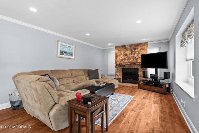 living area with light wood finished floors, baseboards, a fireplace, and ornamental molding