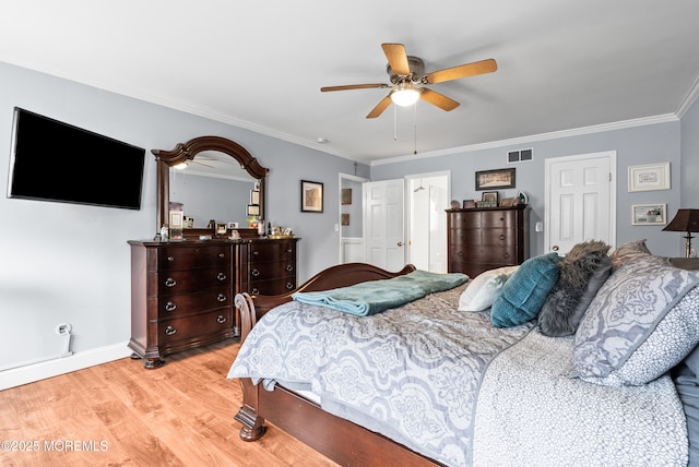 bedroom with baseboards, visible vents, ceiling fan, crown molding, and light wood-type flooring