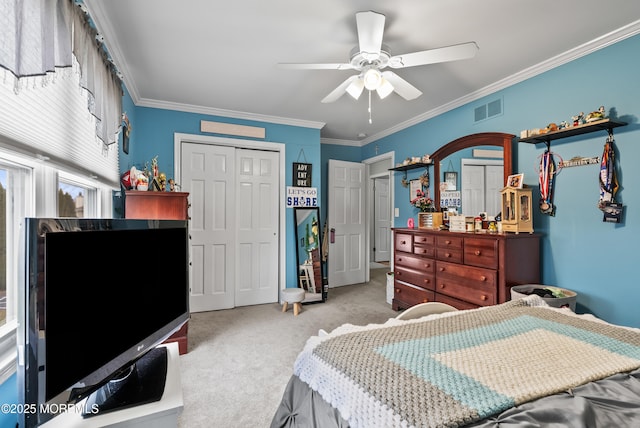 carpeted bedroom with a closet, visible vents, and crown molding