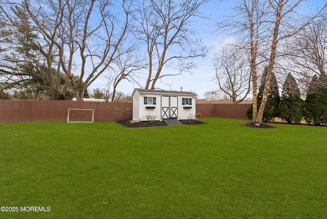 view of yard featuring a fenced backyard, a storage unit, and an outdoor structure