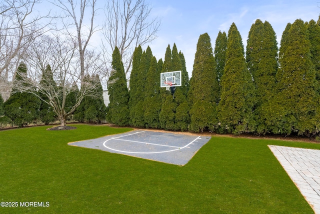 view of sport court featuring community basketball court and a lawn