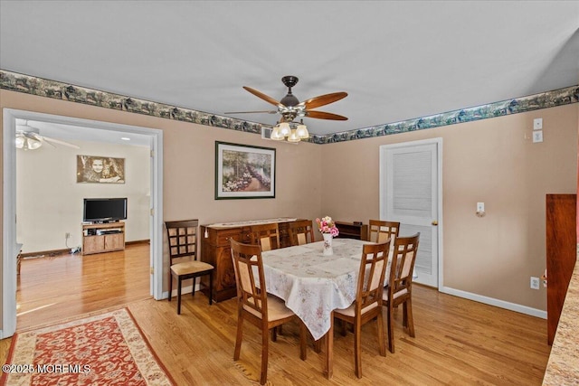 dining area with light wood-style floors, ceiling fan, and baseboards