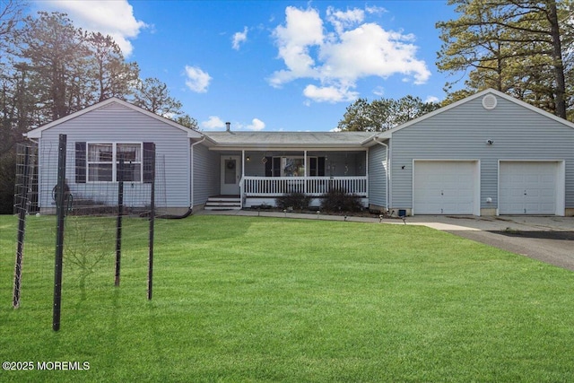 ranch-style house featuring a garage, covered porch, driveway, and a front lawn