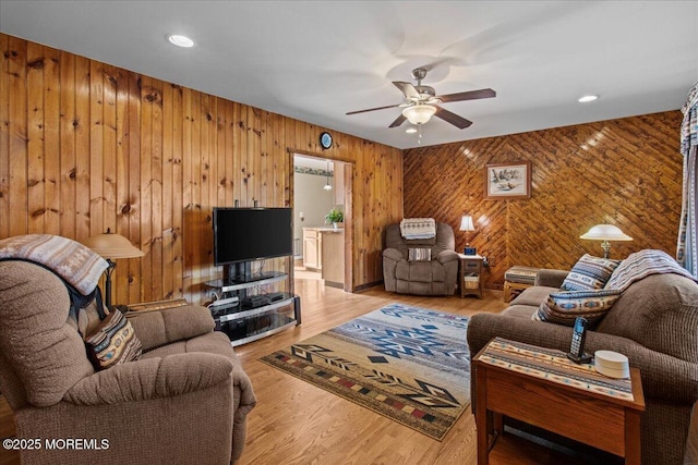 living room featuring wood finished floors, a ceiling fan, and recessed lighting