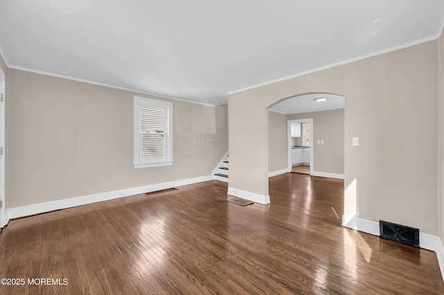 unfurnished room featuring ornamental molding and dark hardwood / wood-style floors