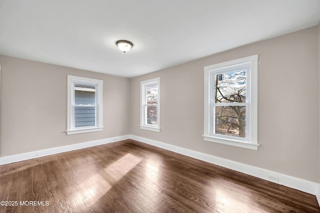 unfurnished room with hardwood / wood-style floors