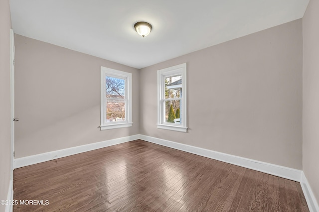 spare room featuring dark wood-type flooring