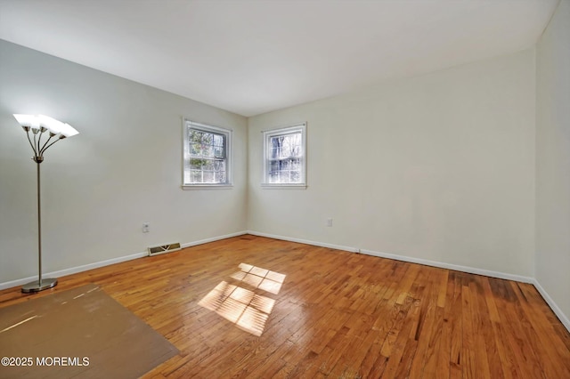 empty room with wood-type flooring