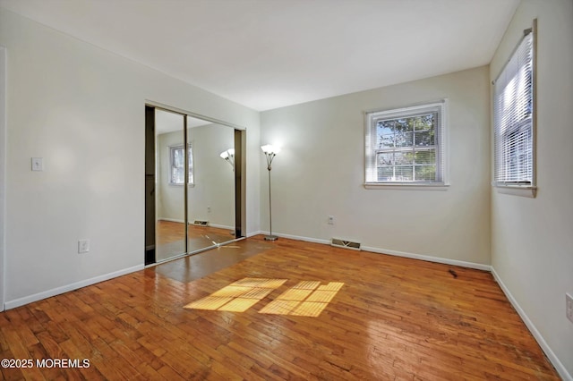 unfurnished bedroom featuring a closet and light hardwood / wood-style flooring