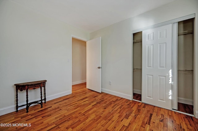 bedroom with light wood-type flooring and a closet