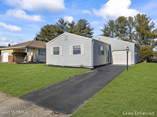 ranch-style house featuring a garage and a front lawn