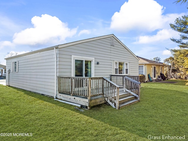 rear view of house with a lawn and a deck