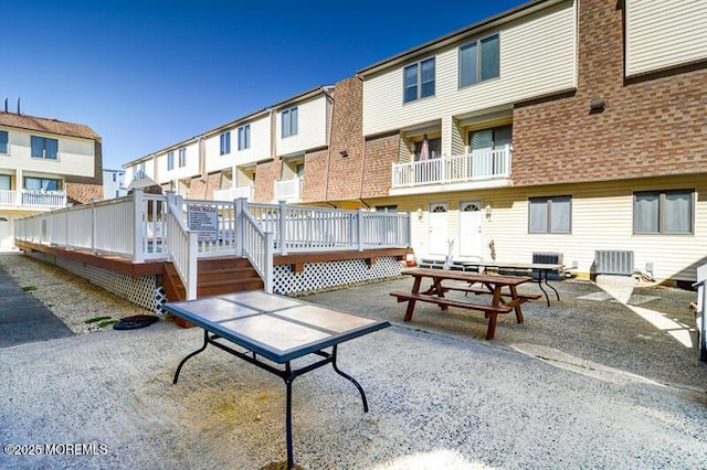 view of home's community featuring a patio and a wooden deck