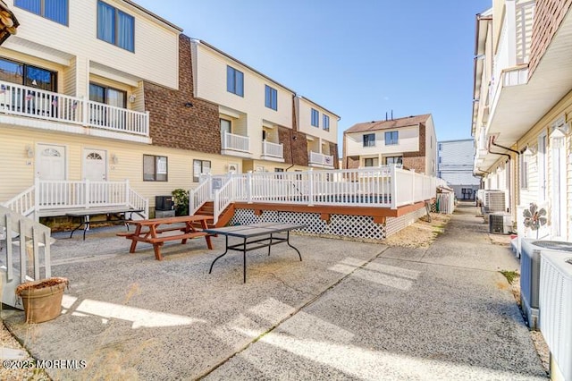 surrounding community with a deck and a patio area