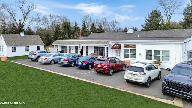 view of car parking featuring a yard