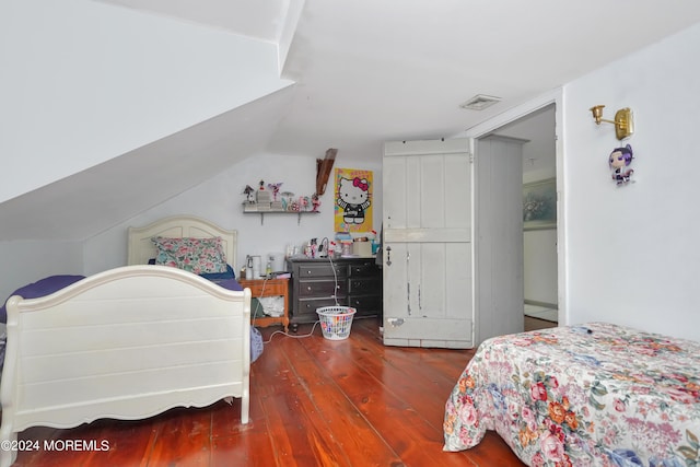 bedroom with vaulted ceiling and dark wood-type flooring