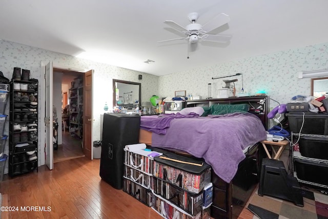 bedroom with ceiling fan and wood-type flooring