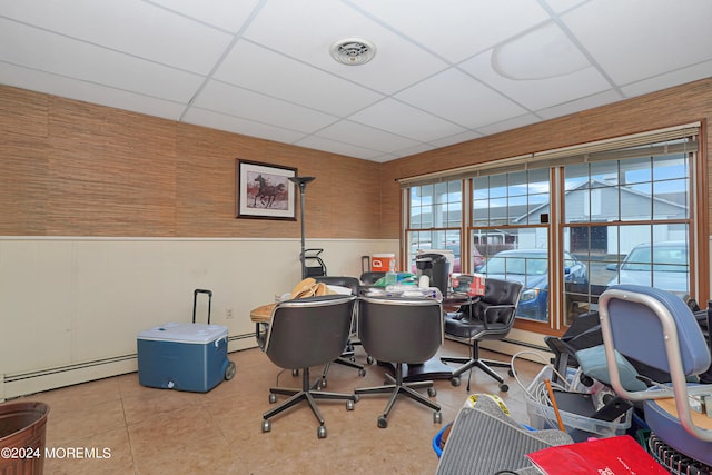 home office with baseboard heating, a paneled ceiling, and tile patterned floors