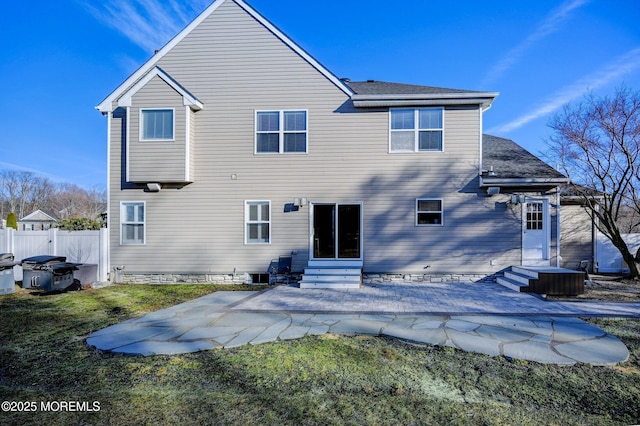 rear view of house featuring a patio and a lawn