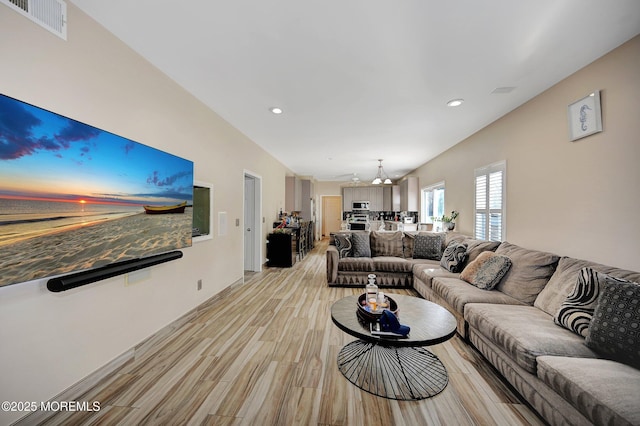 living room featuring a chandelier and light hardwood / wood-style flooring