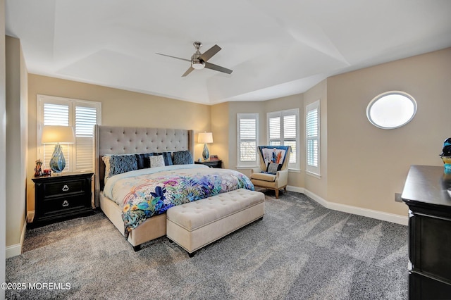 bedroom with a tray ceiling, carpet flooring, and ceiling fan