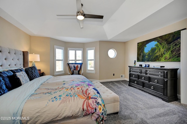 bedroom featuring carpet, ceiling fan, and a tray ceiling