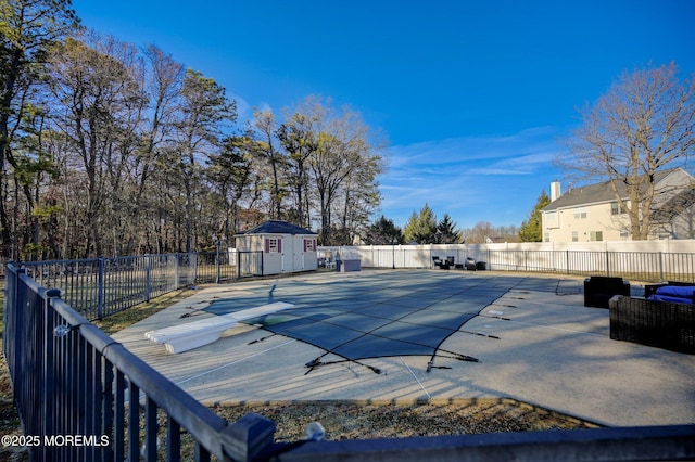 view of pool with a patio area and an outbuilding