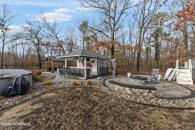 view of yard with an outbuilding, a fire pit, an outdoor bar, and a patio area