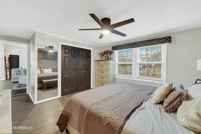 bedroom featuring ornamental molding, hardwood / wood-style flooring, and ceiling fan