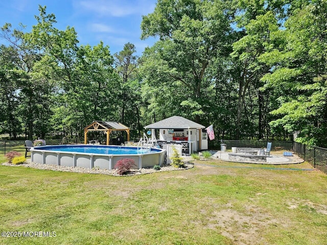 view of swimming pool featuring an outbuilding, a yard, and a gazebo