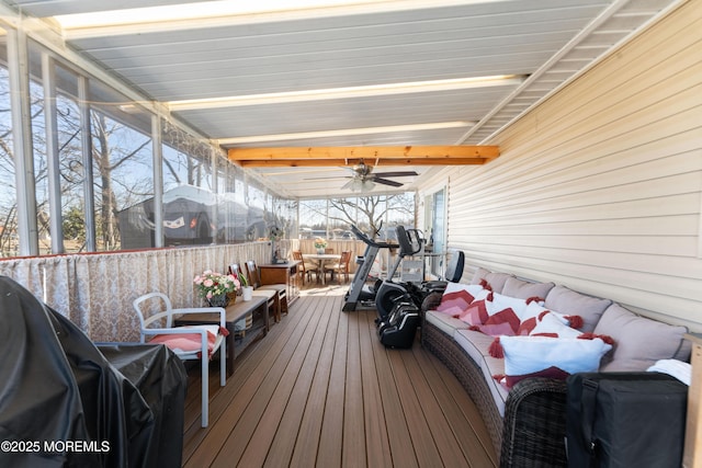 sunroom with beamed ceiling and ceiling fan