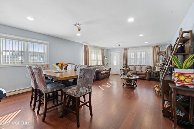 dining room with dark hardwood / wood-style flooring and a baseboard heating unit