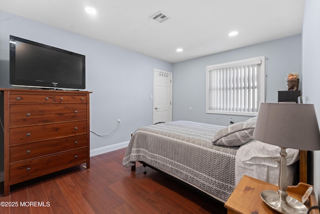 bedroom with dark hardwood / wood-style flooring