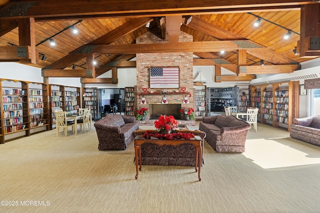 living room with wood ceiling, beam ceiling, high vaulted ceiling, a fireplace, and light colored carpet