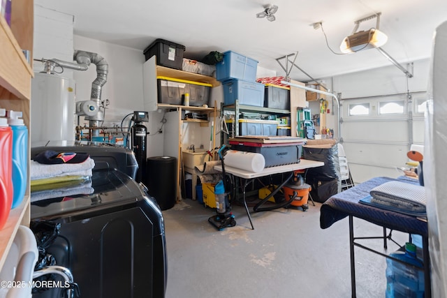 garage with a garage door opener, washer / dryer, and gas water heater