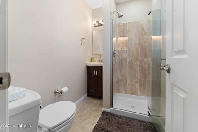 bathroom featuring vanity, a shower with shower door, tile patterned floors, and toilet