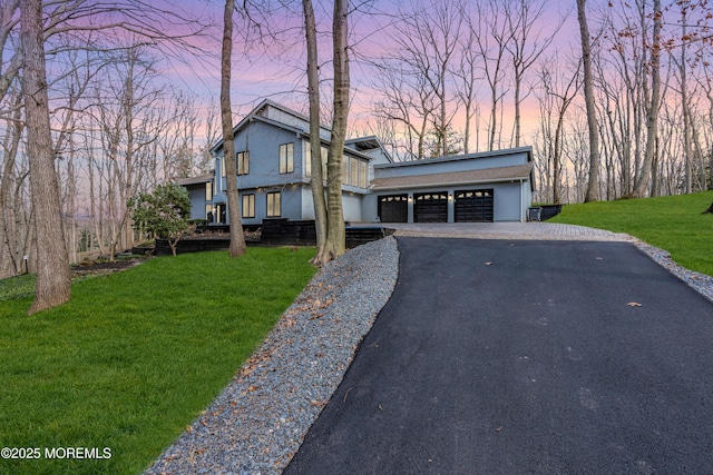 view of front of house with a yard and a garage