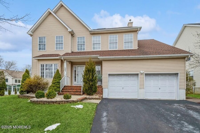 view of front of home with a garage and a front yard