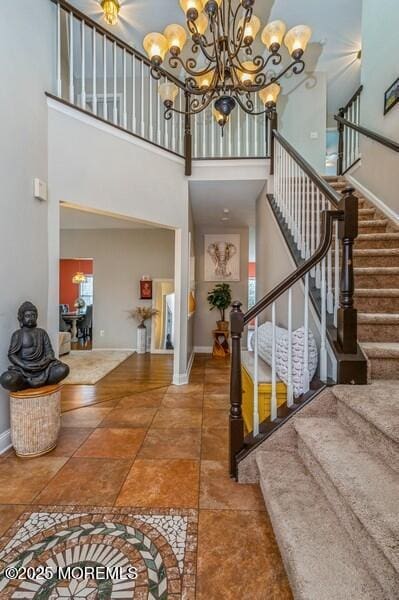 foyer featuring a towering ceiling and a notable chandelier