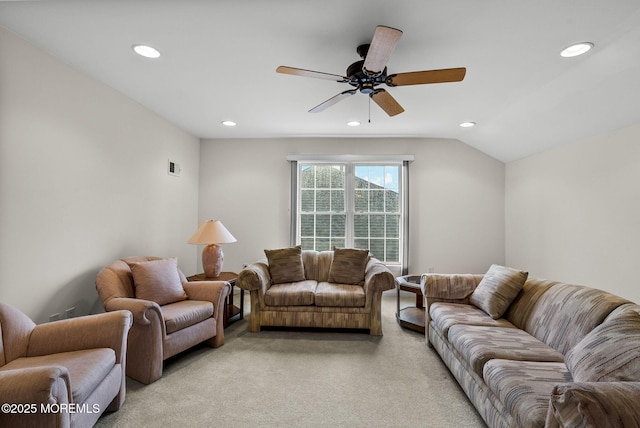 carpeted living room with lofted ceiling and ceiling fan